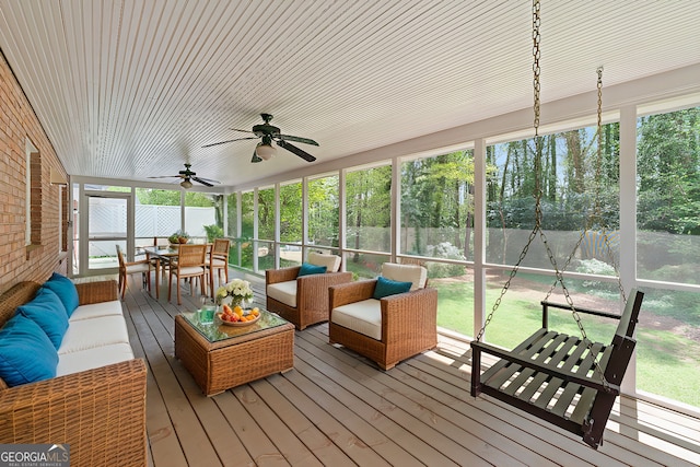 sunroom featuring an outdoor living space, ceiling fan, and plenty of natural light
