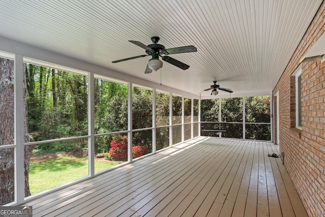 unfurnished sunroom featuring ceiling fan