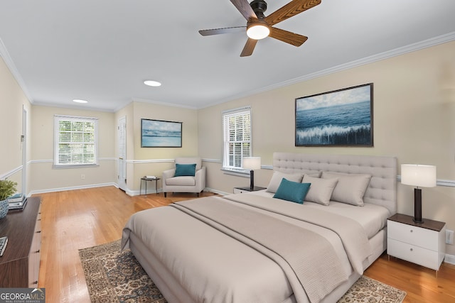 bedroom featuring crown molding, baseboards, multiple windows, and wood finished floors