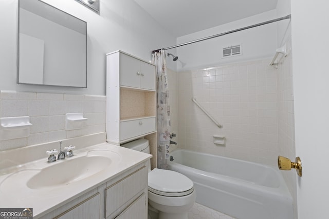 bathroom with shower / bathtub combination with curtain, vanity, visible vents, toilet, and tile walls