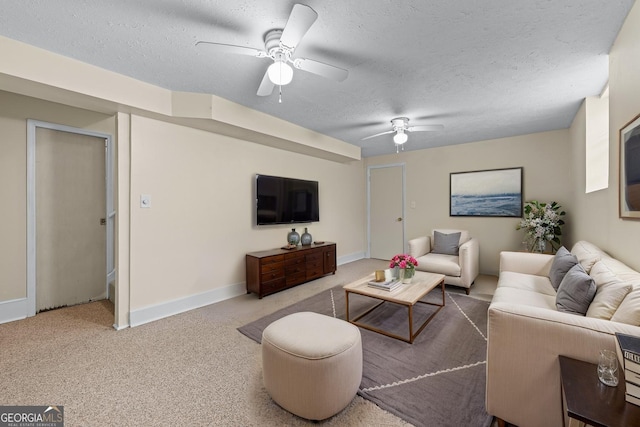 carpeted living room featuring a textured ceiling, baseboards, and a ceiling fan