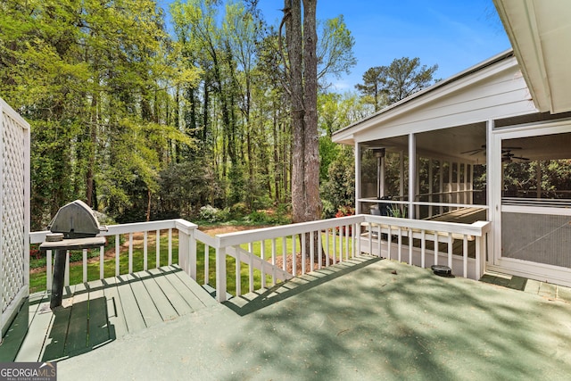 wooden deck with a sunroom