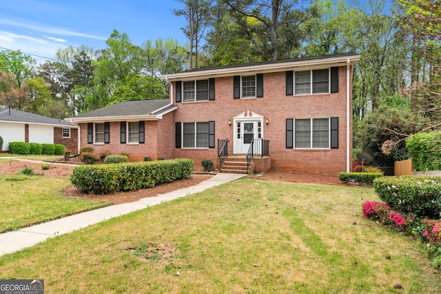 colonial inspired home with a front lawn and brick siding