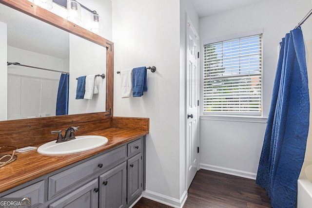 287 Players Cir, Fayetteville, GA 30215 - full bath featuring vanity, a shower with curtain, a tub, wood finished floors, and baseboards