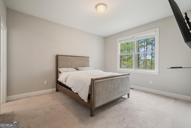 carpeted bedroom featuring baseboards