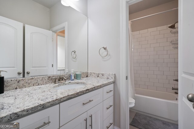 bathroom featuring shower / bath combo, toilet, and vanity