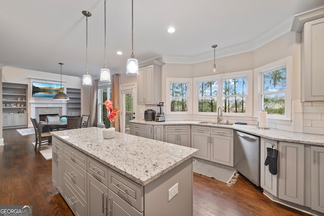 kitchen with stainless steel dishwasher, gray cabinetry, crown molding, and a sink