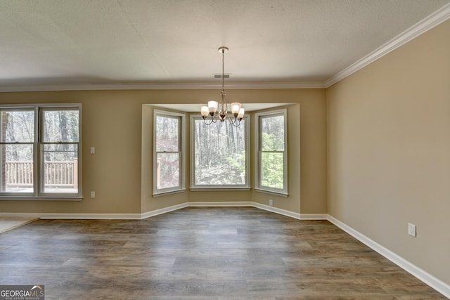 unfurnished dining area featuring a notable chandelier, a textured ceiling, baseboards, visible vents, and dark wood-type flooring