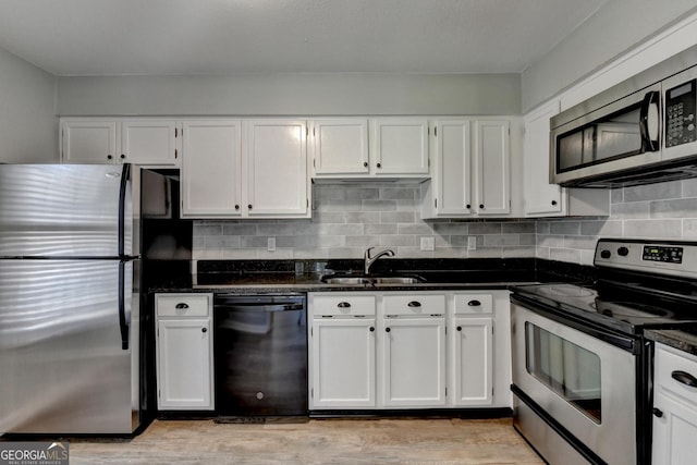 kitchen featuring a sink, white cabinetry, and appliances with stainless steel finishes
