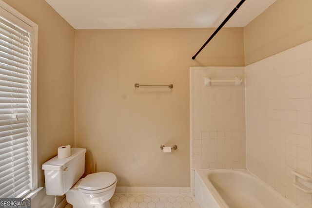 full bathroom with tile patterned flooring, toilet, shower / bathing tub combination, and baseboards
