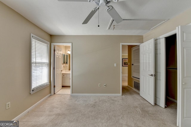 unfurnished bedroom with light carpet, a textured ceiling, baseboards, and visible vents