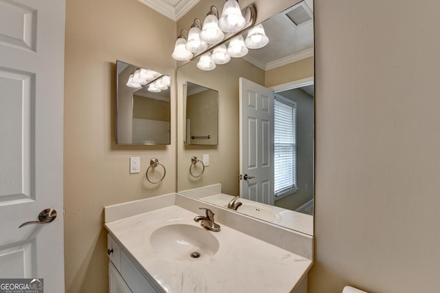 bathroom featuring vanity, crown molding, and visible vents