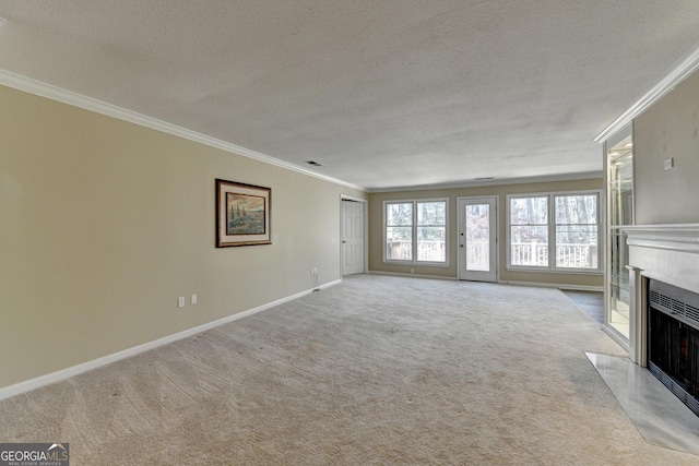 unfurnished living room featuring a fireplace with flush hearth, a textured ceiling, crown molding, baseboards, and carpet floors