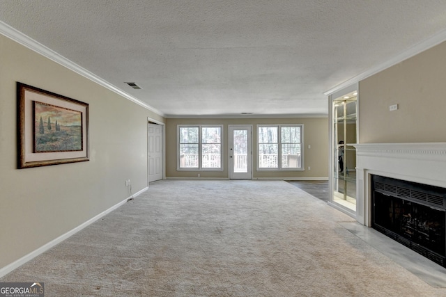 unfurnished living room with crown molding, a fireplace with flush hearth, a textured ceiling, baseboards, and carpet