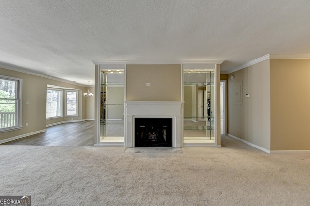 unfurnished living room with a fireplace with flush hearth, carpet flooring, ornamental molding, and a textured ceiling