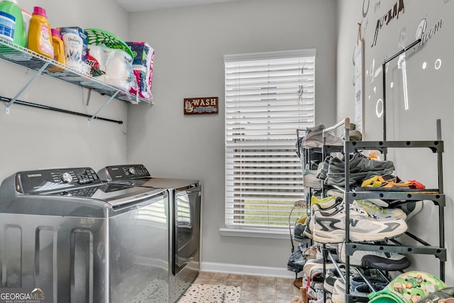 washroom with washer and dryer, laundry area, and baseboards