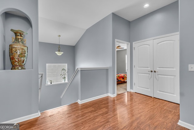 foyer entrance featuring wood finished floors, recessed lighting, and baseboards