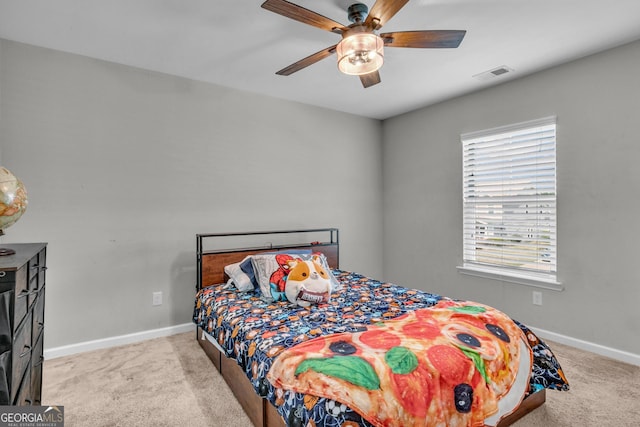bedroom featuring baseboards, visible vents, and light carpet