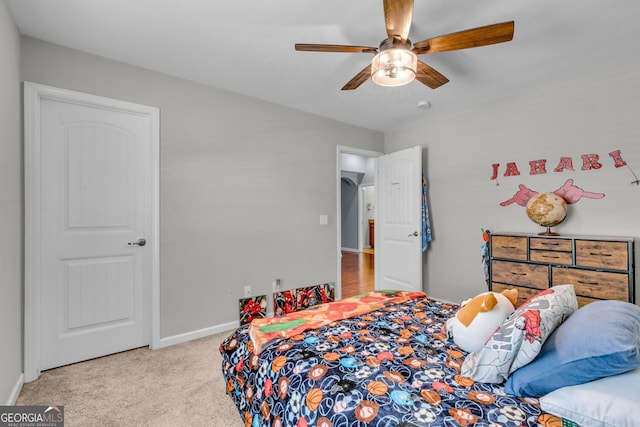 bedroom with baseboards, a ceiling fan, and carpet
