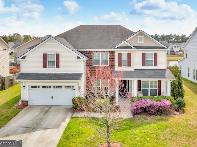 traditional home featuring board and batten siding, fence, driveway, a front yard, and an attached garage
