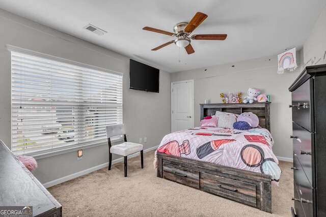 carpeted bedroom with a ceiling fan, visible vents, and baseboards