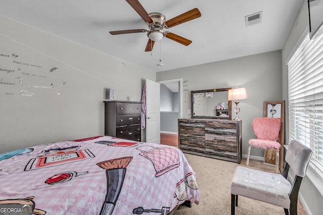 bedroom with visible vents, multiple windows, and carpet floors