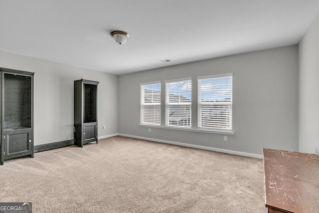 unfurnished bedroom with visible vents, baseboards, and carpet floors