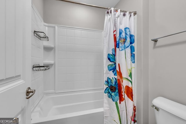 bathroom with shower / bath combo with shower curtain and toilet