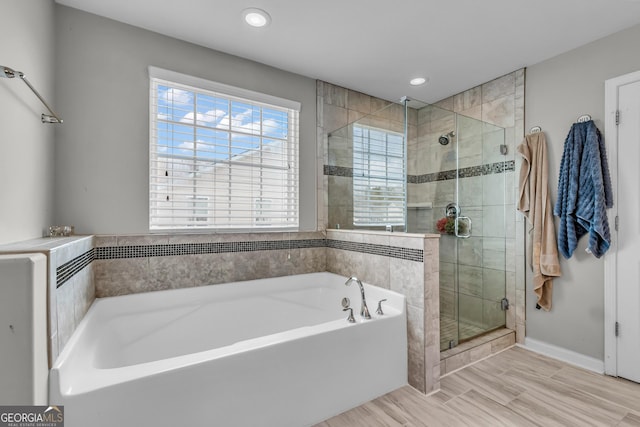 bathroom with baseboards, recessed lighting, a shower stall, and a bath