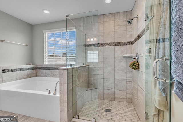 bathroom with a garden tub, recessed lighting, and a stall shower