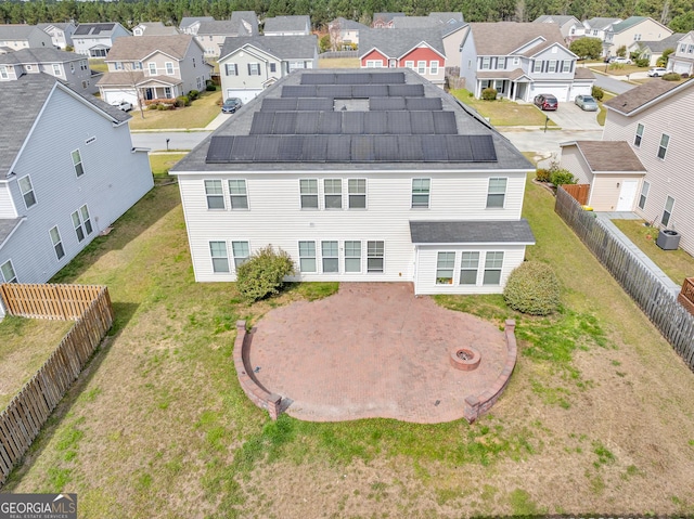 back of property with central AC, a residential view, and a fenced backyard