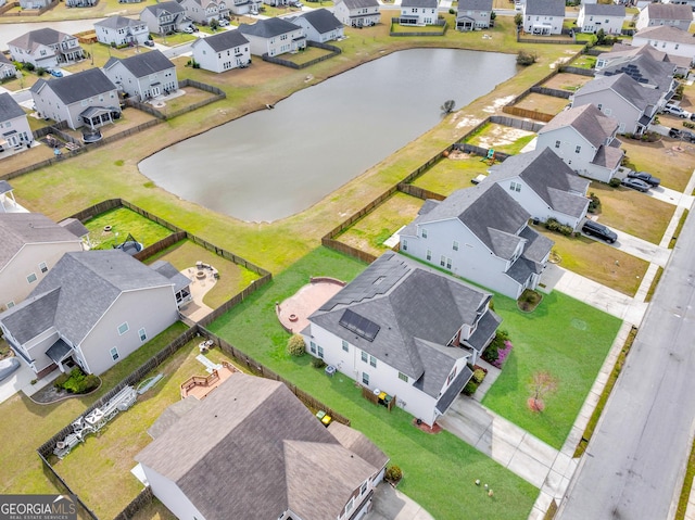 drone / aerial view with a water view and a residential view