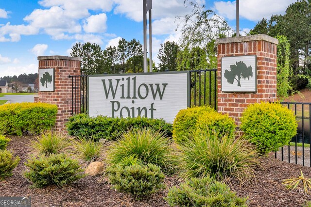 community sign featuring fence