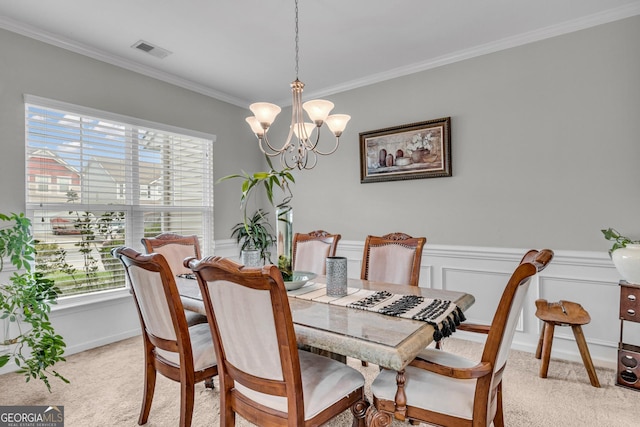 dining room with an inviting chandelier, light colored carpet, visible vents, and crown molding