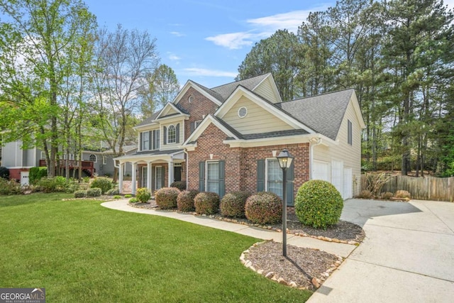 4522 Willow Oak Trl, Powder Springs, GA 30127 - view of front facade with a front yard, concrete driveway, fence, brick siding, and a garage