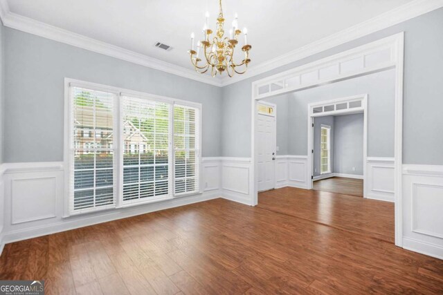 4522 Willow Oak Trl, Powder Springs, GA 30127 - unfurnished dining area featuring a decorative wall, visible vents, a chandelier, ornamental molding, and wood finished floors