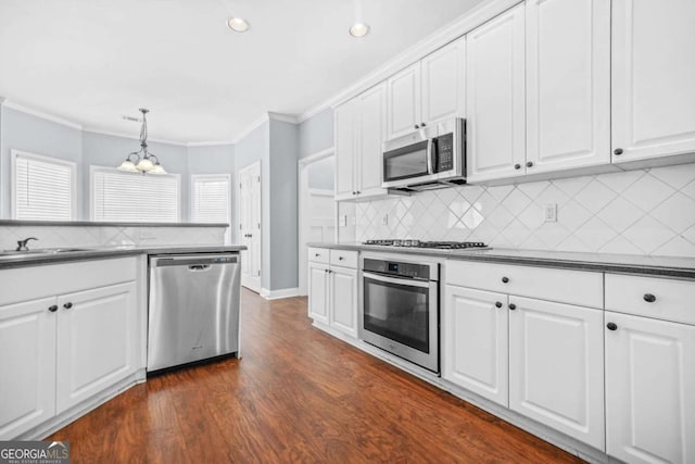 4522 Willow Oak Trl, Powder Springs, GA 30127 - kitchen with a notable chandelier, crown molding, dark countertops, and stainless steel appliances