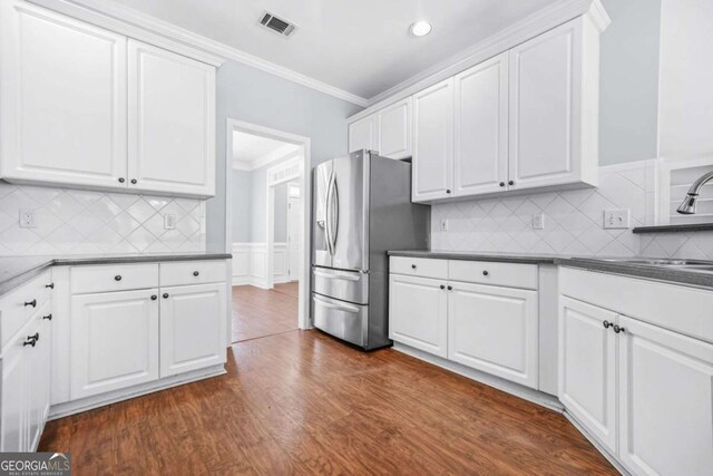 4522 Willow Oak Trl, Powder Springs, GA 30127 - kitchen with ornamental molding, stainless steel fridge with ice dispenser, dark wood finished floors, a sink, and white cabinets