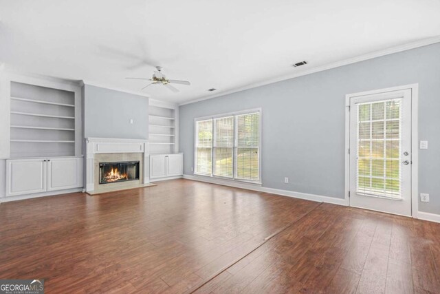 4522 Willow Oak Trl, Powder Springs, GA 30127 - unfurnished living room featuring a high end fireplace, crown molding, baseboards, ceiling fan, and hardwood / wood-style floors