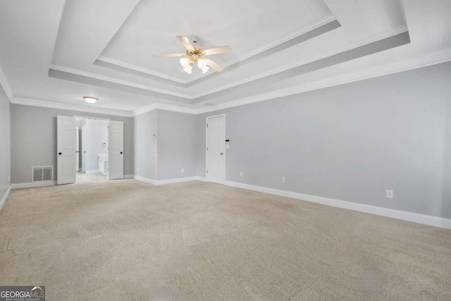 4522 Willow Oak Trl, Powder Springs, GA 30127 - empty room featuring a tray ceiling, crown molding, a ceiling fan, light carpet, and visible vents