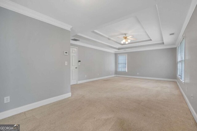 4522 Willow Oak Trl, Powder Springs, GA 30127 - spare room featuring a tray ceiling, light carpet, baseboards, visible vents, and ceiling fan
