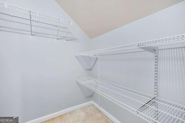 4522 Willow Oak Trl, Powder Springs, GA 30127 - walk in closet with carpet flooring and lofted ceiling