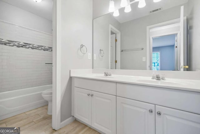 4522 Willow Oak Trl, Powder Springs, GA 30127 - bathroom featuring visible vents, a sink, toilet, and wood finished floors