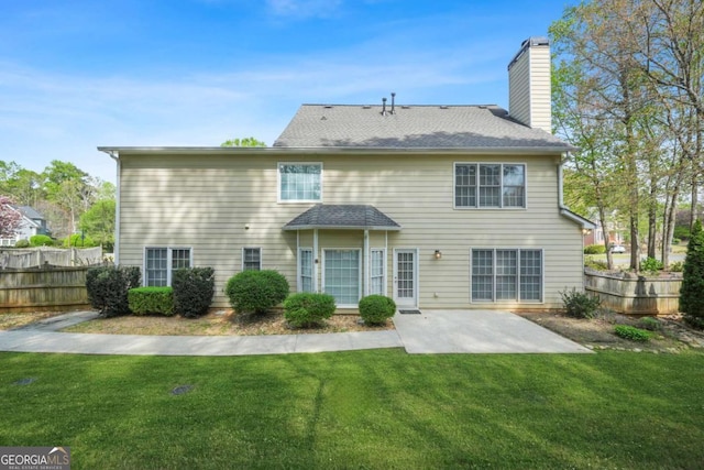 4522 Willow Oak Trl, Powder Springs, GA 30127 - rear view of property featuring fence, a patio, a chimney, roof with shingles, and a yard