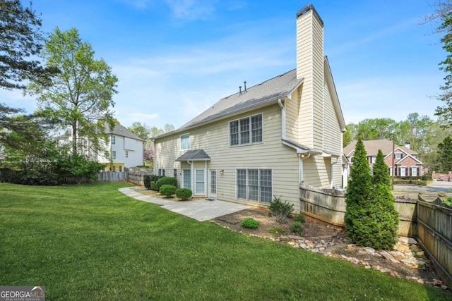 4522 Willow Oak Trl, Powder Springs, GA 30127 - back of house featuring a fenced backyard, a lawn, a chimney, and a patio area