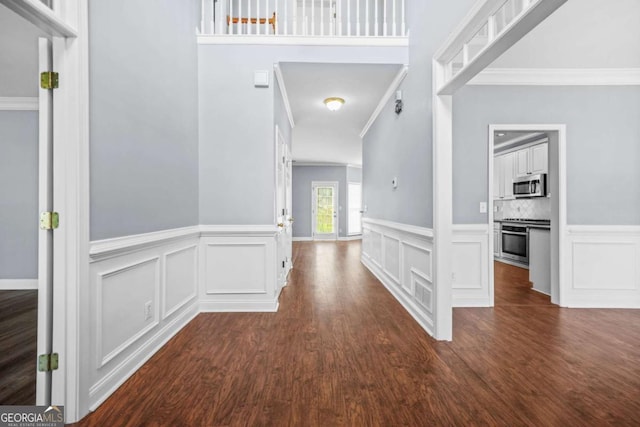4522 Willow Oak Trl, Powder Springs, GA 30127 - hallway featuring dark wood-type flooring, a decorative wall, and crown molding