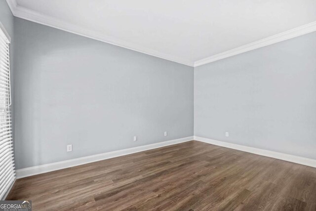 4522 Willow Oak Trl, Powder Springs, GA 30127 - empty room featuring dark wood-type flooring, baseboards, and crown molding