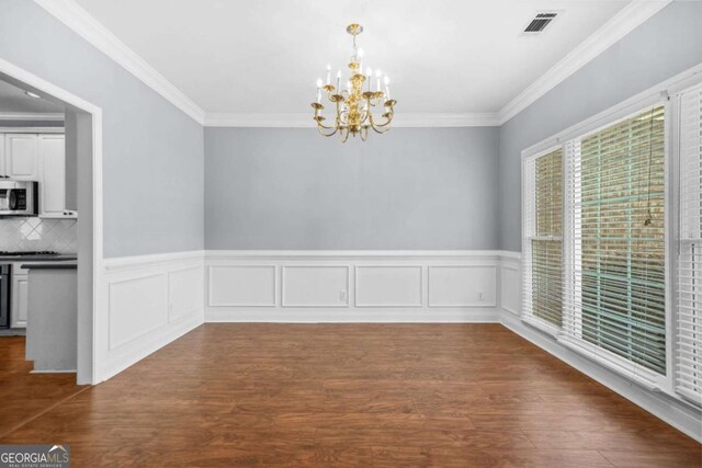 4522 Willow Oak Trl, Powder Springs, GA 30127 - unfurnished dining area with dark wood-type flooring, visible vents, a chandelier, and crown molding