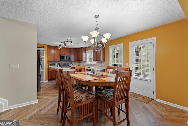 368 Yellowwood Dr, Sharpsburg, GA 30277 - dining area featuring a chandelier and a textured ceiling