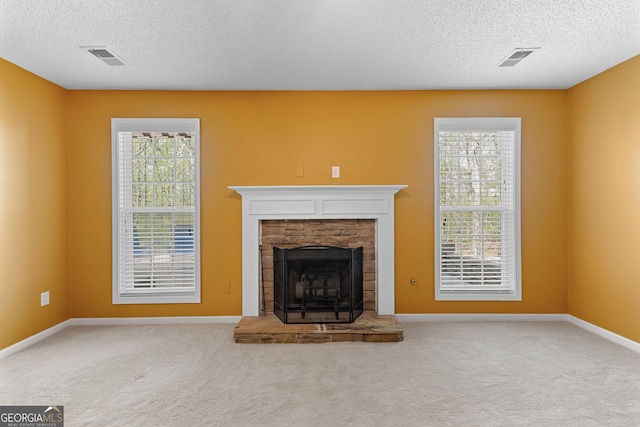 368 Yellowwood Dr, Sharpsburg, GA 30277 - unfurnished living room featuring a textured ceiling, carpet floors, plenty of natural light, and a fireplace